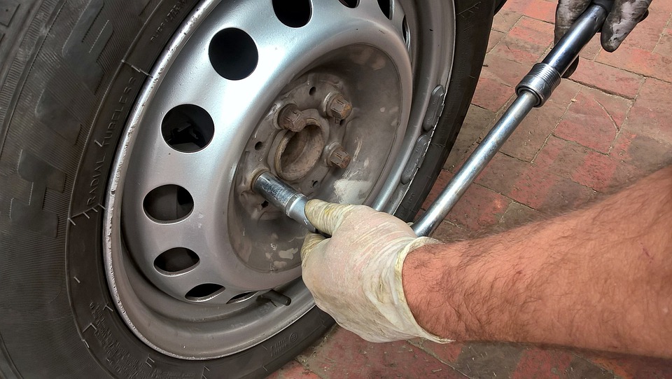 Garagiste qui change un pneu de voiture